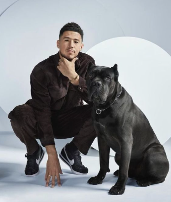 An image of Devin Booker with his Dog