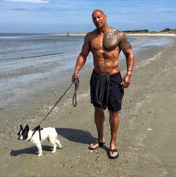 An image of Dwayne Johnson with his Dog