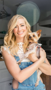 An image of Beth Behrs with her Dog