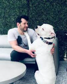 An image of Steven Crowder withhis Dog